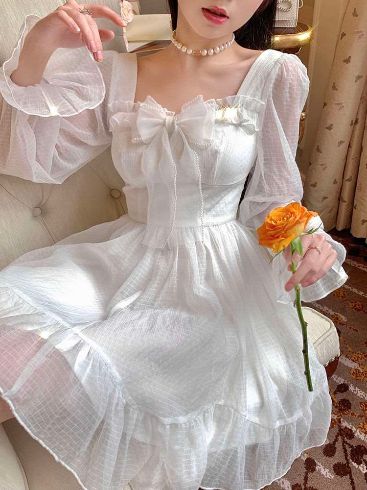 Model sitting in the Cloudlight Fairy Dress holding an orange rose