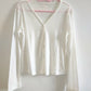 White Cloudy Daydream Cardigan, showcasing V-neckline and button front.