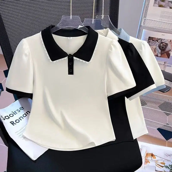 Front view of the Collar Me Cute Polo Top in white with black collar, shown with the black-with-white and white-with-blue colorways behind it.