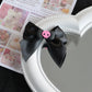 Creep It Cute Hair Bows — Single black satin hair bow with pink skull center on a heart mirror.