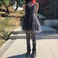 Model wearing Dark Fairy Tulle Dress outdoors full-body view, styled with black shoes, black leg warmers, and fishnet skull tights
