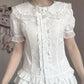 Model wearing the white Darling Honey Bear Blouse with fitted waist and satin bow.