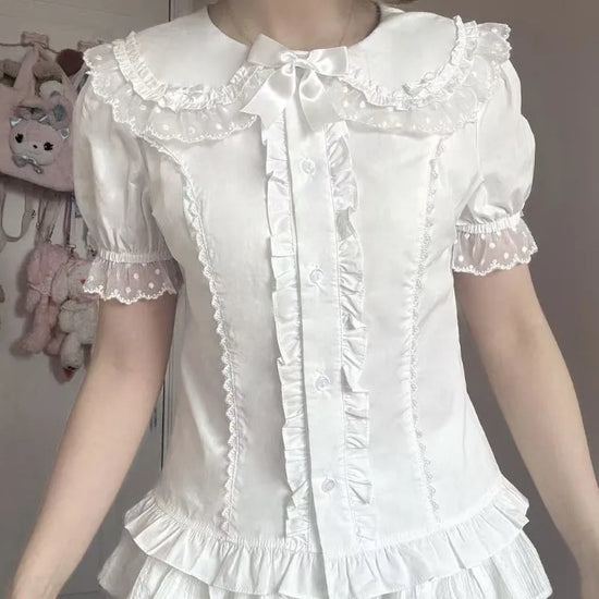 Model wearing the white Darling Honey Bear Blouse with fitted waist and satin bow.
