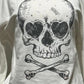 Close-up of bold skull and crossbones graphic on Dead Cute Off-Shoulder Top
