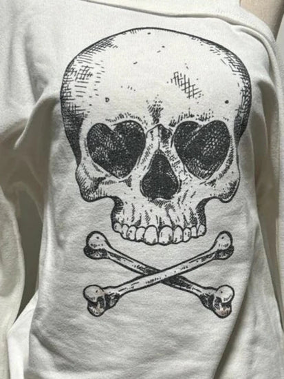 Close-up of bold skull and crossbones graphic on Dead Cute Off-Shoulder Top