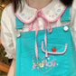Doodle Darling Collar Blouse layered under turquoise overalls with its pastel Peter Pan collar visible