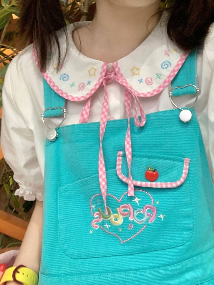 Doodle Darling Collar Blouse layered under turquoise overalls with its pastel Peter Pan collar visible