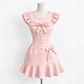 The Dotted Darling Dress, a pink polka-dot mini dress, on a mannequin.