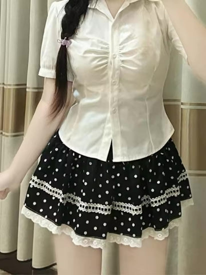 Close front view of a model wearing the Dotted Doll Lace Skort, highlighting its polka dots and white lace-trimmed tiers.