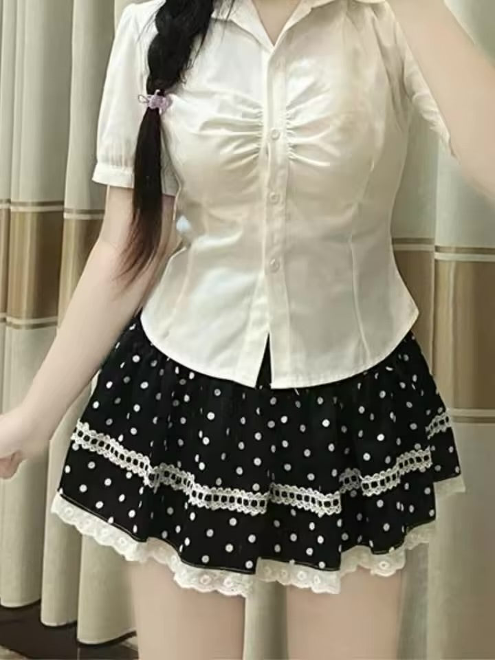 Close front view of a model wearing the Dotted Doll Lace Skort, highlighting its polka dots and white lace-trimmed tiers.