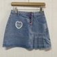 The Dual Darling Denim Skirt hanging on the hanger without added bows