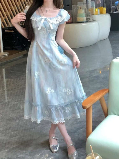 Model wearing the midi Ethereal Flower Princess Dress, showing its flowy fit and ruffled, lace-trimmed hem.