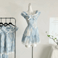 A close-up of the mini Ethereal Flower Princess Dress on a mannequin next to a rack hanging the mini and midi versions of the dress.