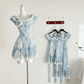 The mini Ethereal Flower Princess Dress on a mannequin, with the full view of the mini and midi versions of the dress hanging on the wall behind it.