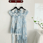 The mini and midi versions of the Ethereal Flower Princess Dress hanging side by side on a wall.