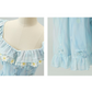 Close-up of details on the Ethereal Flower Princess Heavenly Bloom Midi Dress in light blue, like the daisy embroidered neckline and ruffled hemline.