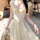Close-up of daisy embroidery at neckline on the Ethereal Flower Princess Heavenly Bloom Midi Dress in light yellow.