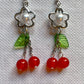 Detailed close-up of cherry charm and pearl bead on the Fairy Cherry Pearl Earrings