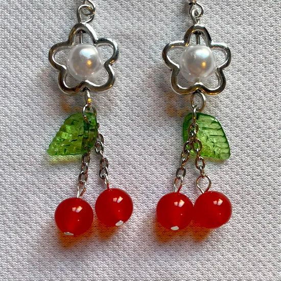 Detailed close-up of cherry charm and pearl bead on the Fairy Cherry Pearl Earrings