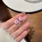 Delicate ombré rose earrings in soft pink and blue hues, held gracefully from the Garden Party Pastel Earrings set.