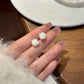 White rose earrings, held gracefully from the Garden Party Pastel Earrings set.