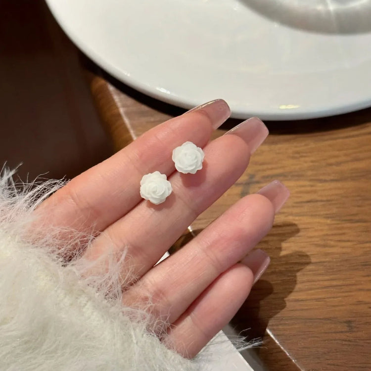 White rose earrings, held gracefully from the Garden Party Pastel Earrings set.