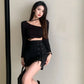 Model wearing the Laced With Attitude Mini Skort, showing the black ties and metal eyelets of the skort