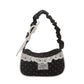 The Lacy Dotling Purse, a black polka-dot lace-trimmed purse, isolated by itself on a white background.