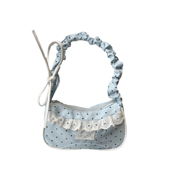 The Lacy Dotling Purse, a light blue polka-dot lace-trimmed purse, isolated by itself.
