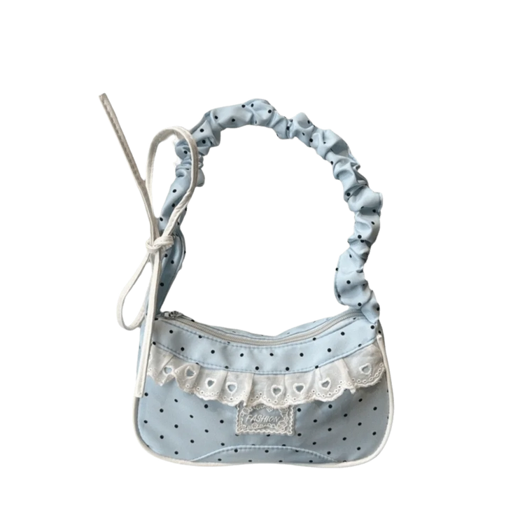 The Lacy Dotling Purse, a light blue polka-dot lace-trimmed purse, isolated by itself.