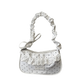 The Lacy Dotling Purse, a white polka-dot lace-trimmed purse, isolated by itself.