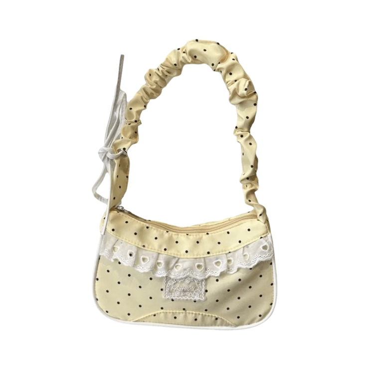The Lacy Dotling Purse, a yellow polka-dot lace-trimmed purse, isolated by itself.