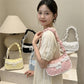 Model holding the Lacy Dotling Purse, a pink polka-dot lace-trimmed purse, with yellow, blue, white, and black color options behind her.
