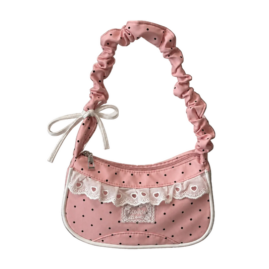 The Lacy Dotling Purse, a pink polka-dot lace purse, on a white background.