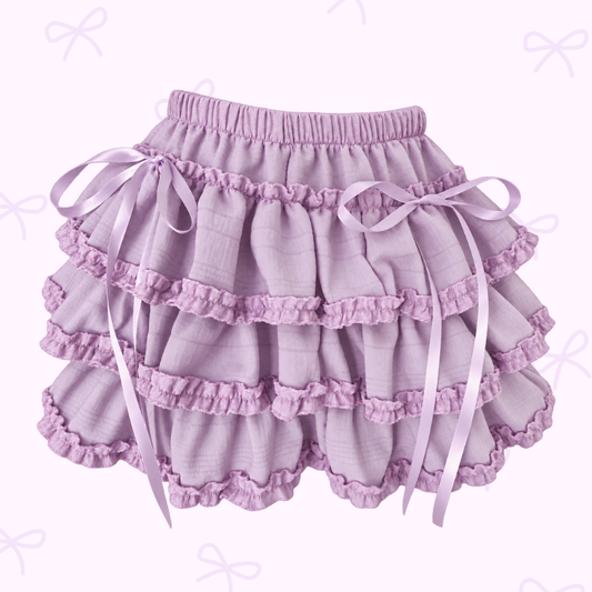 The Lavender Lullaby Skort on a soft purple background with purple ribbon ties.