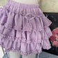 Angled view of the Lavender Lullaby Skort, displayed on a dress form with gathered waistband and ribbon details.
