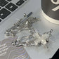 Close-up of the Liquid Metal Butterfly Hair Clip’s front and back, showing the metallic clasp and butterfly wing detail.