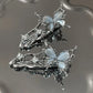 Flatlay of two Liquid Metal Butterfly Hair Clips arranged aesthetically.