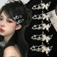 Model wearing the Liquid Metal Butterfly Hair Clip on dark hair, showcasing silver metallic butterflies along the side.