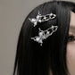 Model with straight black hair wearing two Liquid Metal Butterfly Hair Clips.