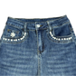 Front close-up view of the Main Mood Cloud-Stretch Flare Jeans in the style Pearly Bliss, featuring alternating small and medium pearls outlining the front pockets and a pearl flower on the fifth pocket.