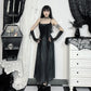 Model standing with hands on hips wearing the Midnight Butterfly Maxi Dress, showing the waistline and butterfly pattern.