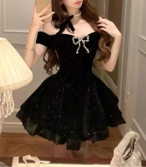 Angled front view of the Midnight Gala Bow Dress on a model, showing the sparkly velvet and jeweled bow.