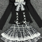 Flat lay of the complete Midnight Manor Skort Set displaying the faux two-piece sweater with corset-inspired details and the coordinating plaid skort.
