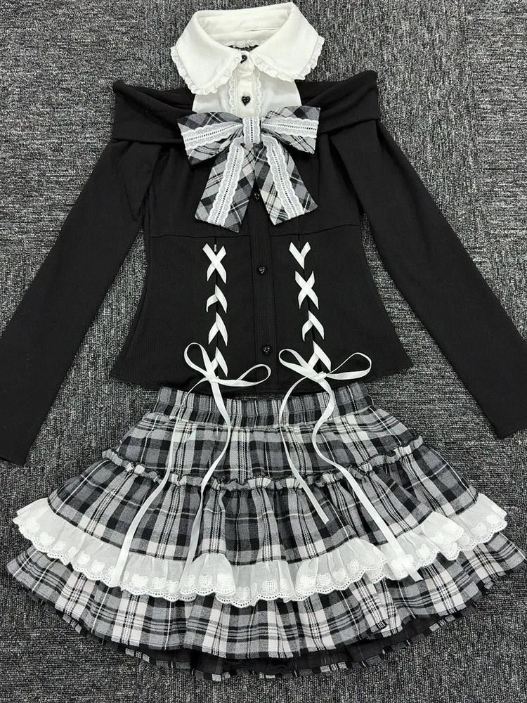 Flat lay of the complete Midnight Manor Skort Set displaying the faux two-piece sweater with corset-inspired details and the coordinating plaid skort.