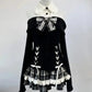 Midnight Manor Skort Set displayed on a mannequin highlighting the faux two-piece sweater and layered plaid skort.