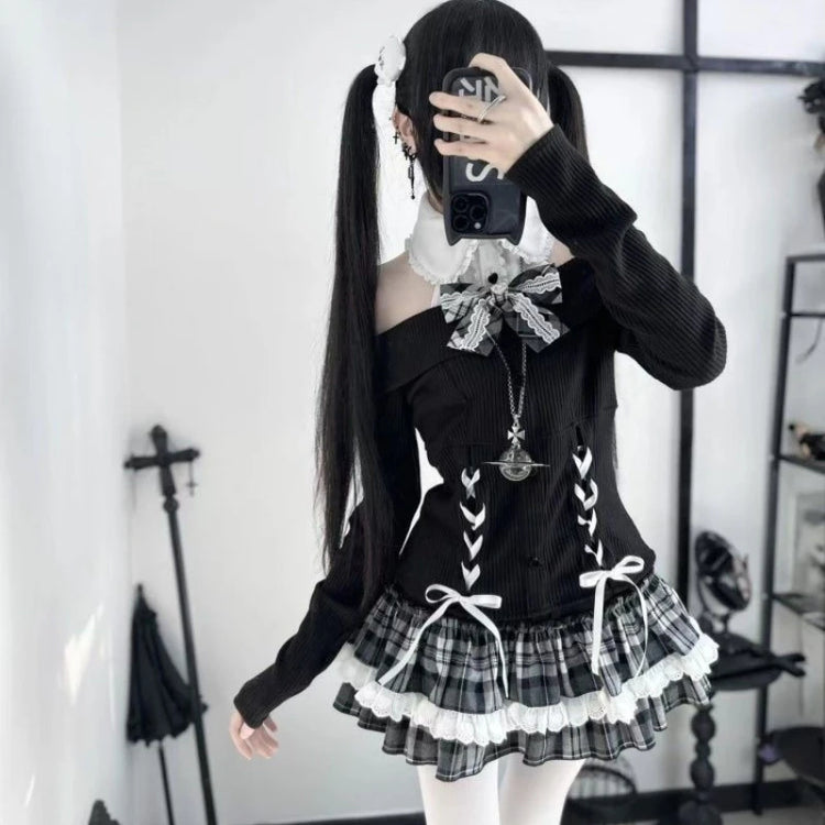 Model wearing the Midnight Manor Skort Set featuring a long-sleeve sweater with a faux layered design, halter off-the-shoulder neckline, corset-inspired lace-up front, black heart-shaped buttons, statement bow, and a plaid skort with built-in shorts.