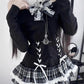 Three-quarter view of the model wearing the Midnight Manor Skort Set featuring the halter off-the-shoulder sweater and layered plaid skort.