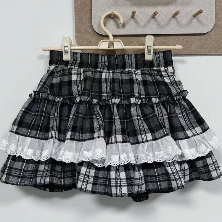 The layered plaid skort from the Midnight Manor Skort Set featuring built-in shorts and a comfortable elastic waistband on a hanger.