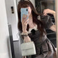 Mirror selfie of model in the Midnight Mourning Baby Doll Dress, styled with pearl headband and accessories